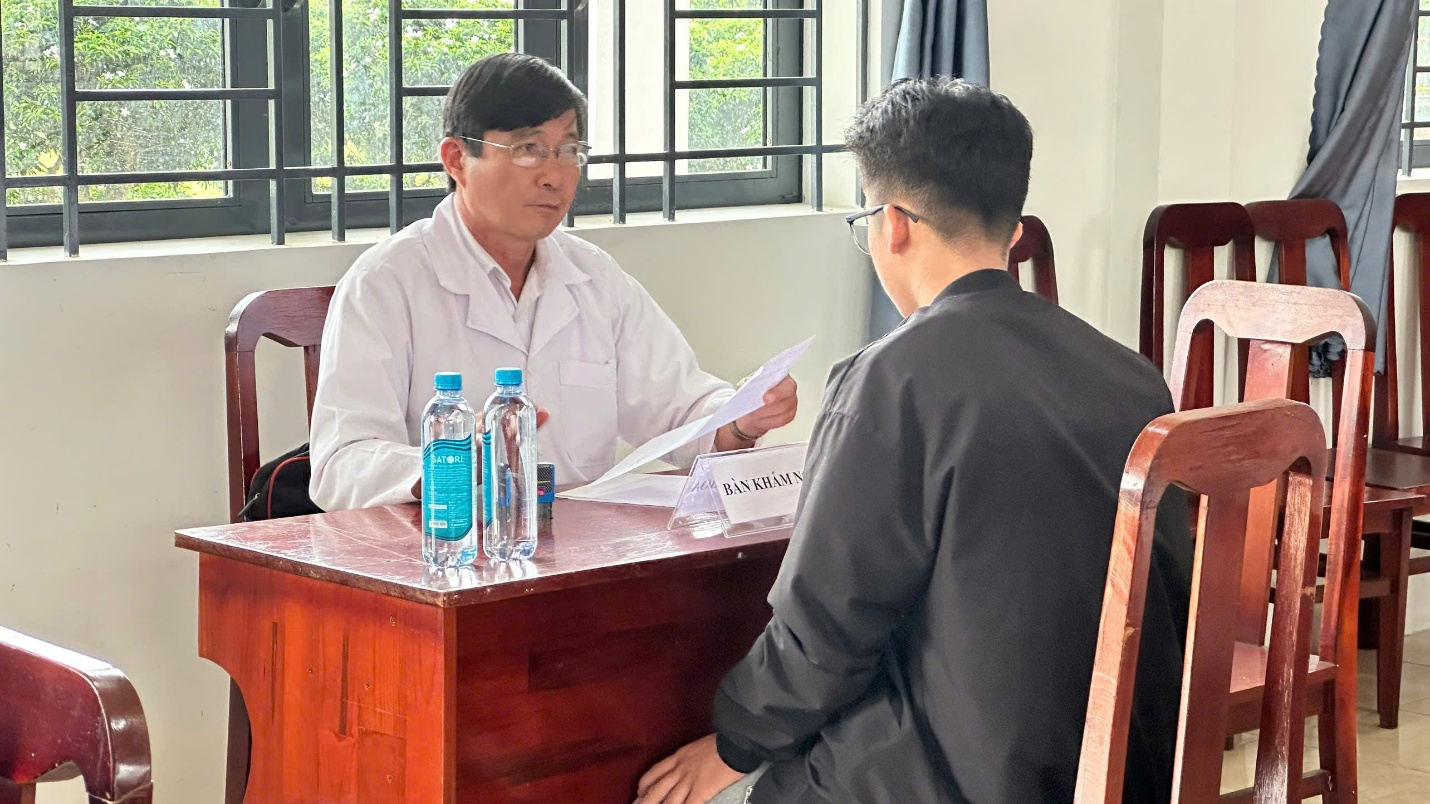 A person in a white coat sitting at a table with a person in a black suit

AI-generated content may be incorrect.